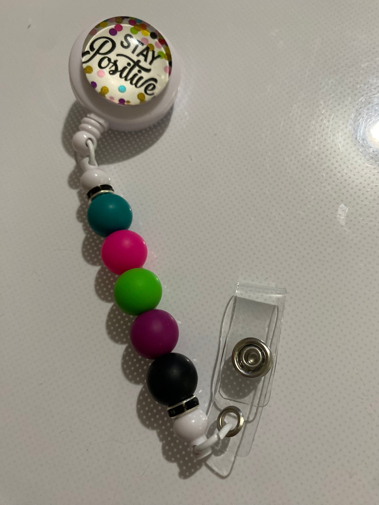 “Stay Positive” badge reel holder - 1