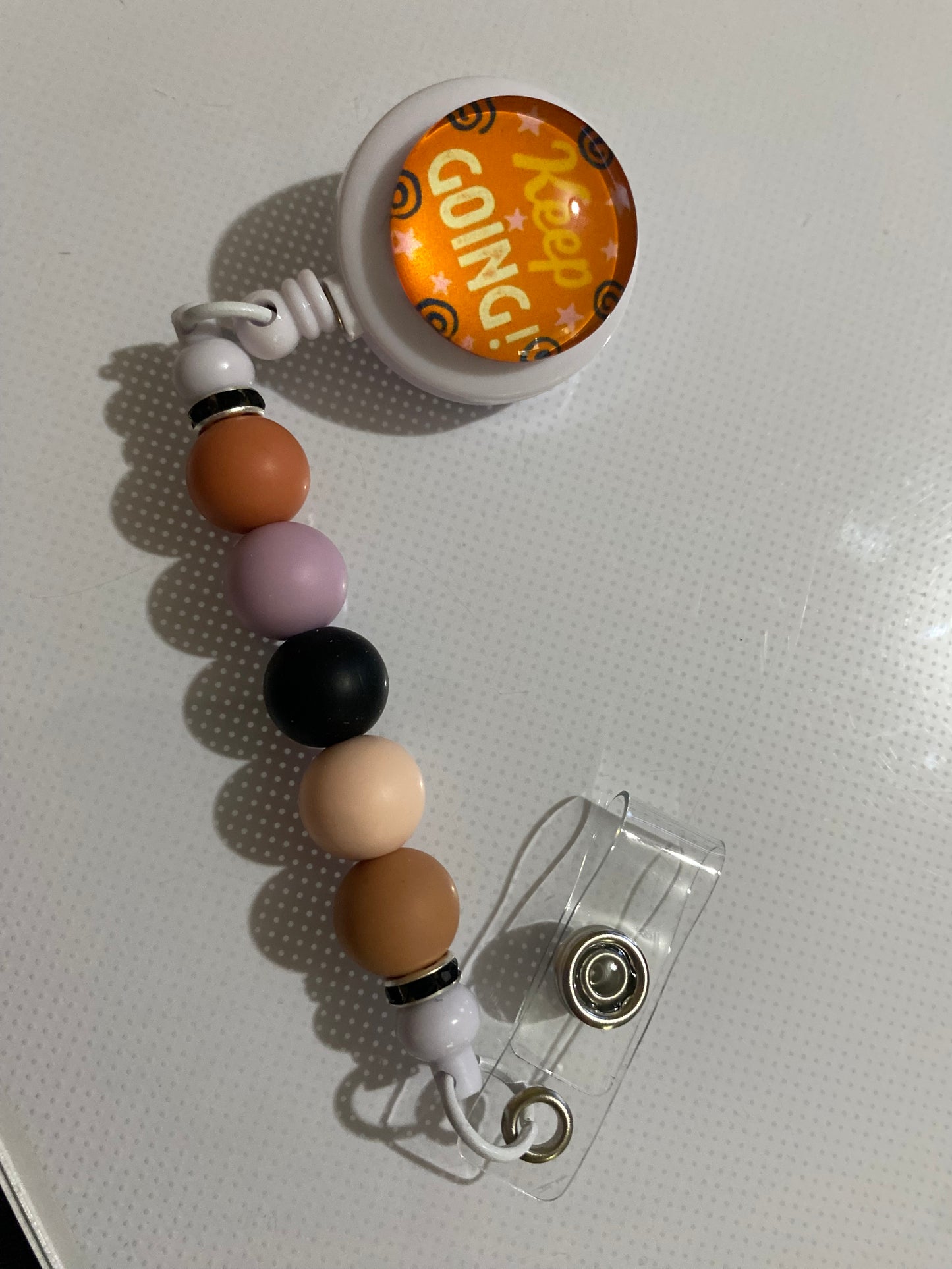 “Keep Going” badge reel holder