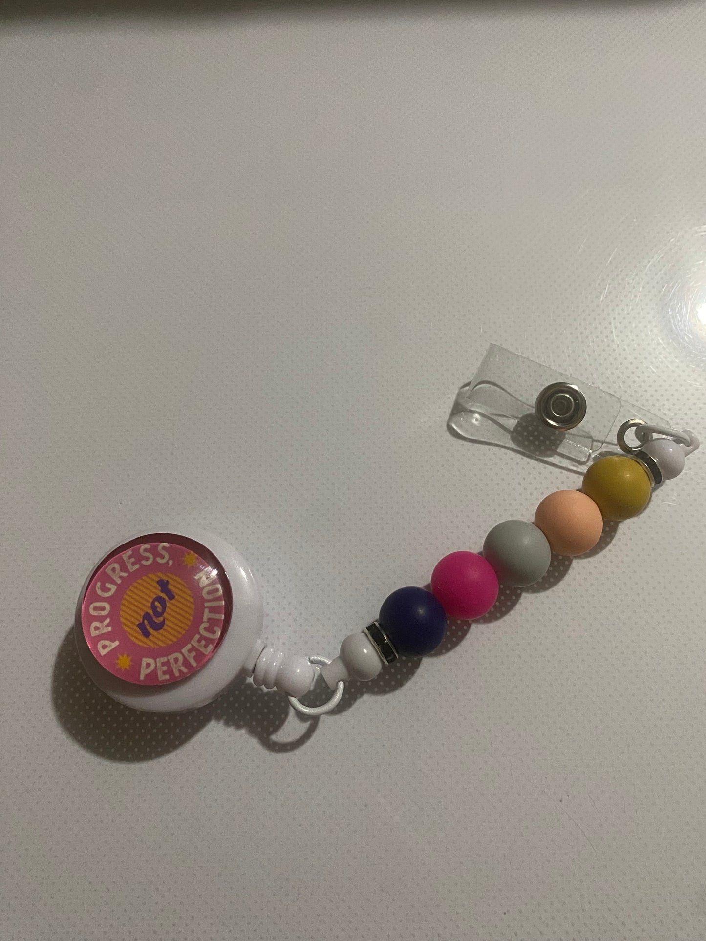 “Progress not Perfection” badge reel holder
