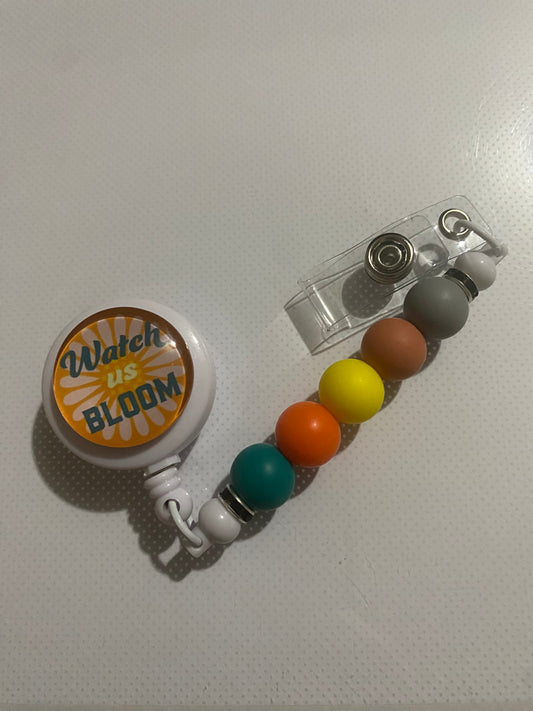 “Watch Us Bloom” badge reel holder