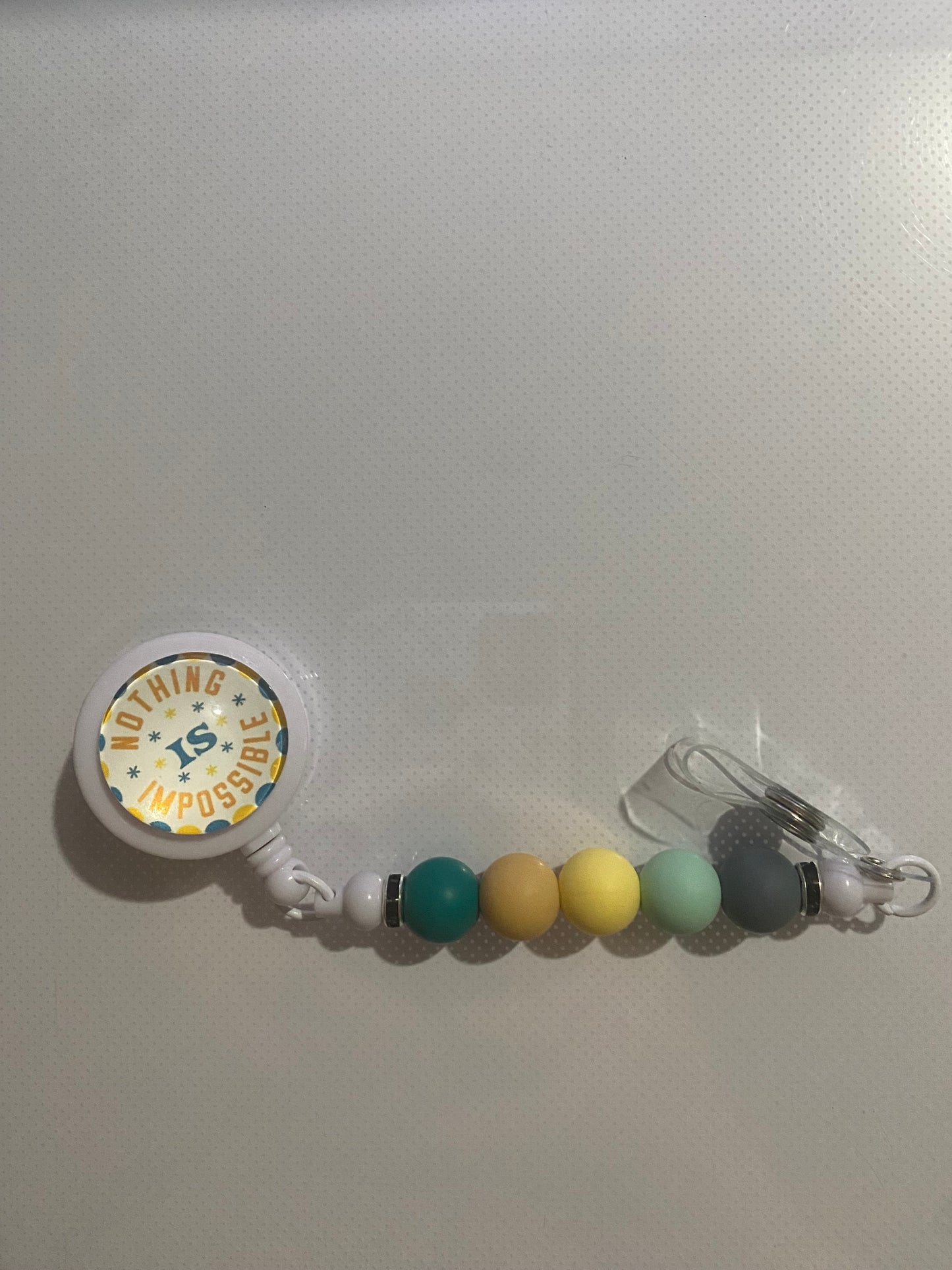 “Nothing is Impossible” badge reel holder