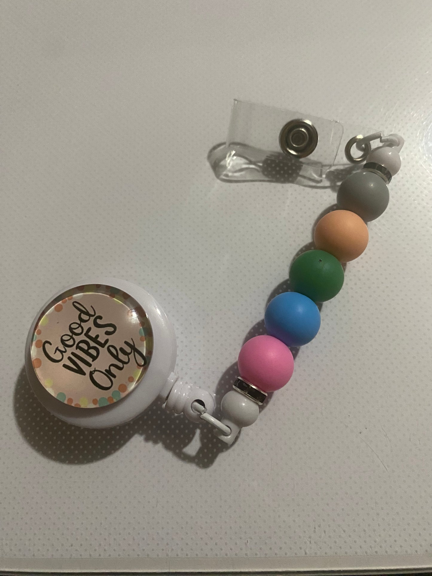 “Good Vibes Only” badge reel holder